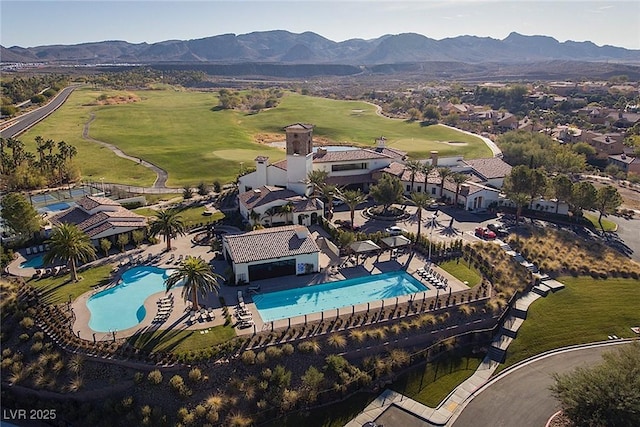 birds eye view of property with golf course view and a mountain view