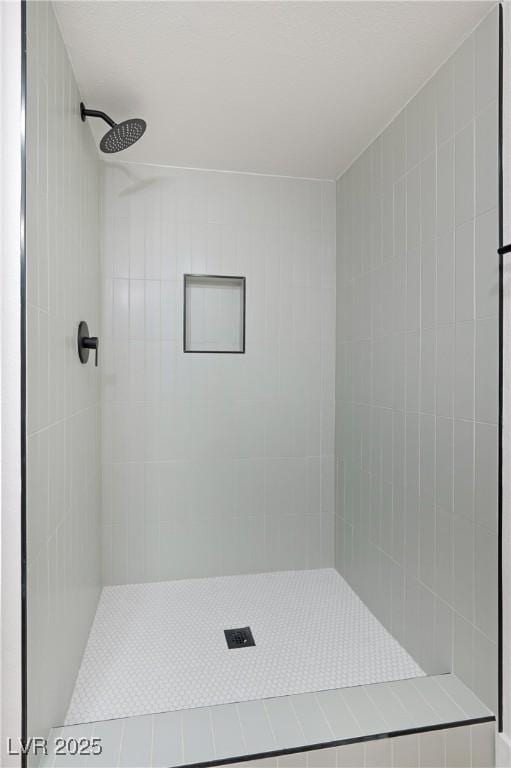 bathroom with tiled shower