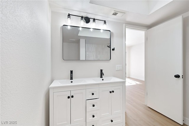 bathroom with hardwood / wood-style floors and vanity