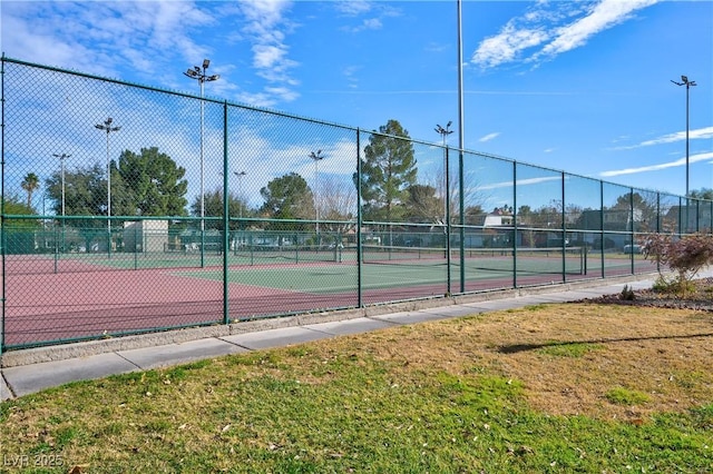 view of sport court featuring a lawn