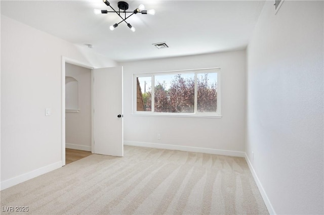 unfurnished bedroom with light carpet and a notable chandelier