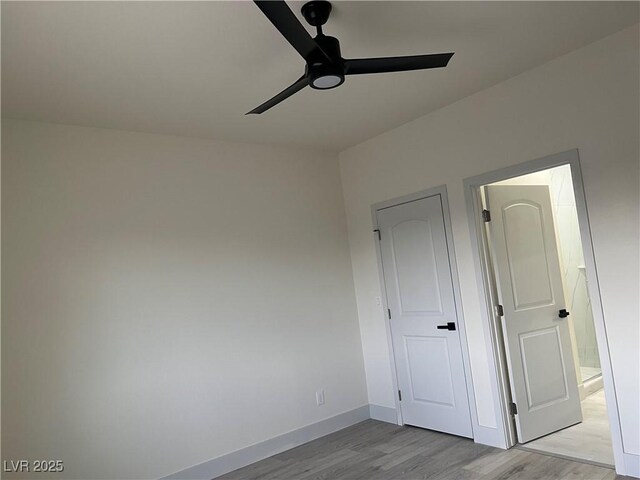 unfurnished room with light wood-type flooring and ceiling fan