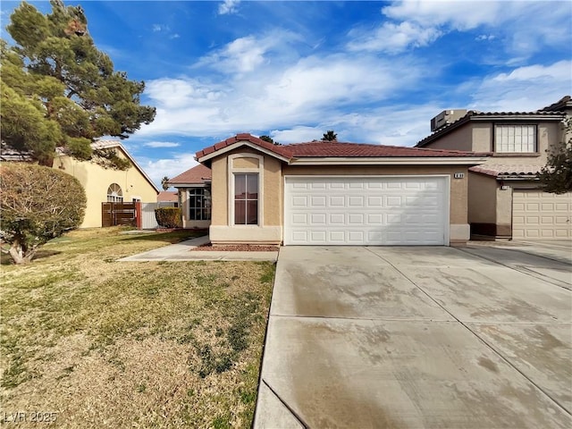 view of front of property featuring a garage and a front lawn