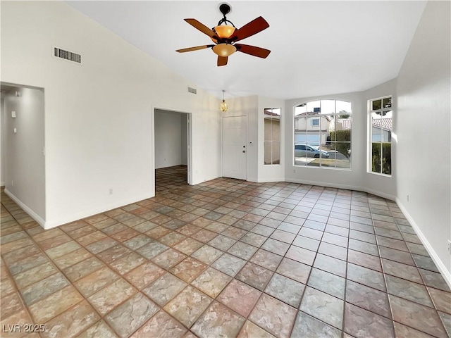 spare room featuring tile patterned floors, ceiling fan, and vaulted ceiling