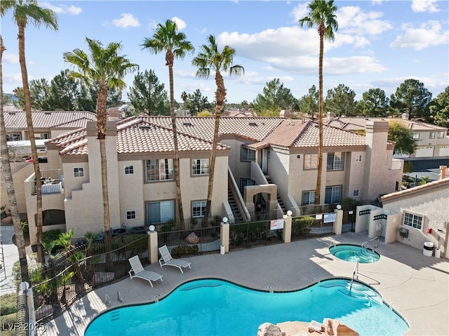 view of pool featuring a patio area and a community hot tub