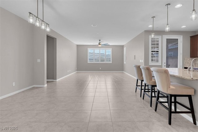 dining room featuring a ceiling fan, recessed lighting, light tile patterned flooring, and baseboards