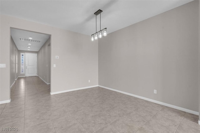 empty room featuring visible vents and baseboards