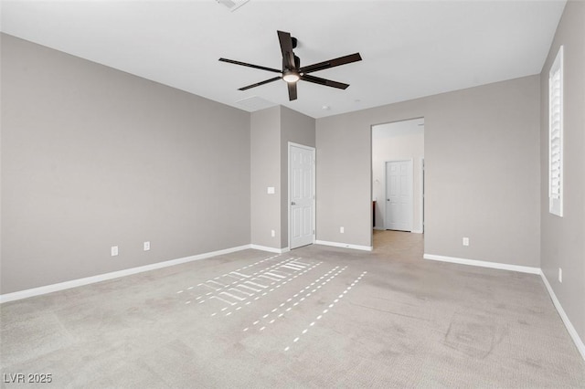 empty room with light carpet, ceiling fan, and baseboards