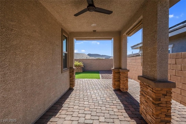 view of patio / terrace with a fenced backyard and ceiling fan