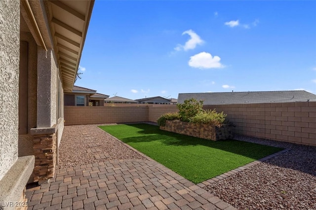 view of yard featuring a patio area and a fenced backyard