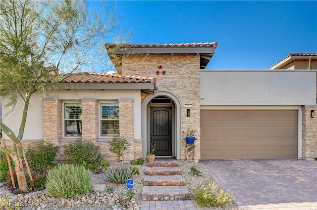 mediterranean / spanish house with a garage