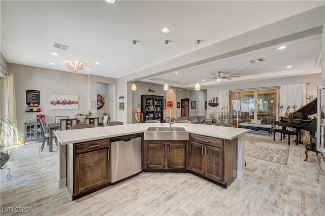 kitchen with ceiling fan, dishwasher, sink, decorative light fixtures, and dark brown cabinets