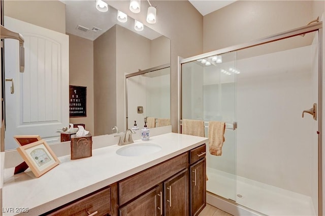 bathroom with vanity and a shower with shower door