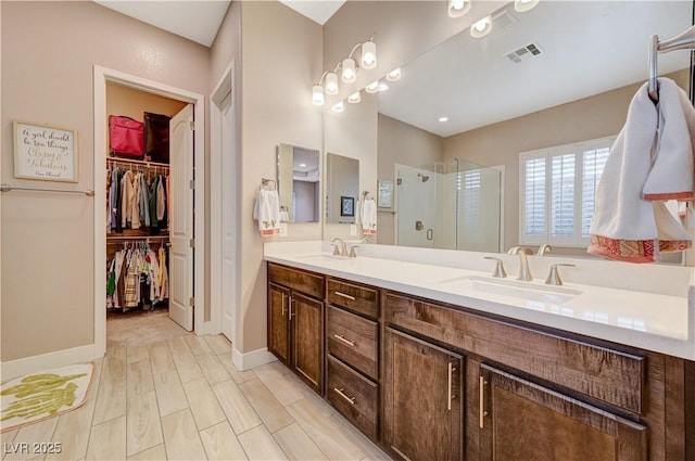 bathroom with hardwood / wood-style floors, vanity, and walk in shower