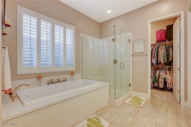 bathroom with separate shower and tub, plenty of natural light, and hardwood / wood-style floors