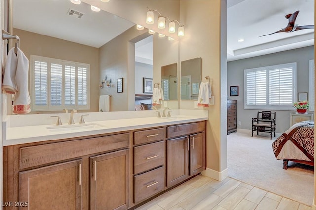 bathroom with ceiling fan and vanity