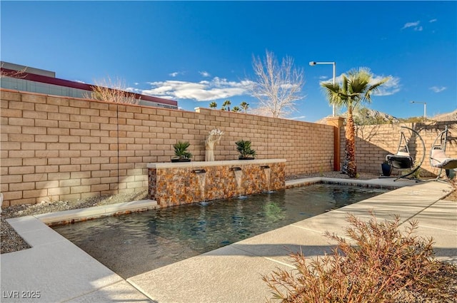 view of pool featuring pool water feature