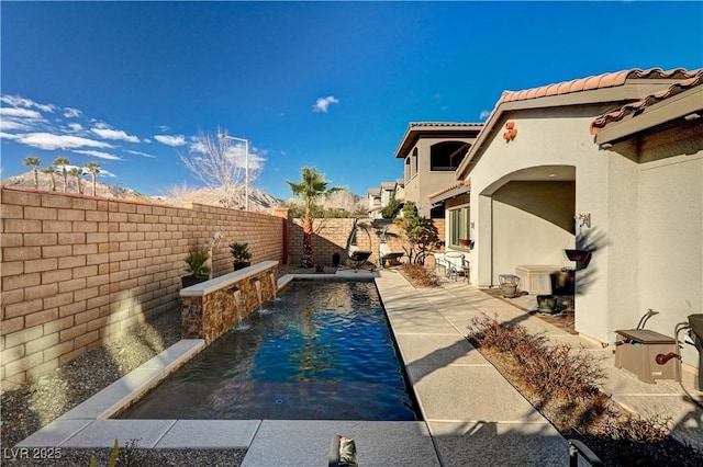 view of swimming pool featuring pool water feature