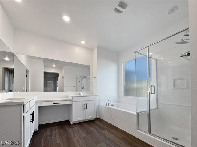 bathroom featuring hardwood / wood-style flooring, vanity, and shower with separate bathtub