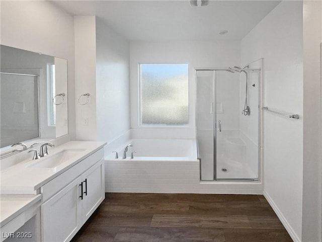 bathroom featuring hardwood / wood-style floors, vanity, and independent shower and bath