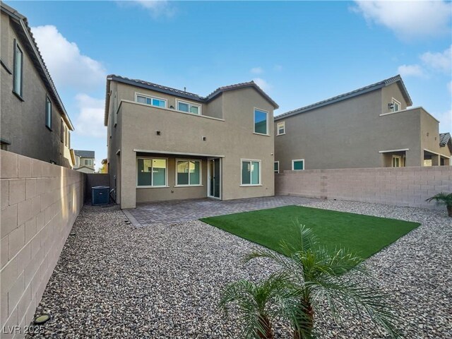 back of property featuring a patio and central AC