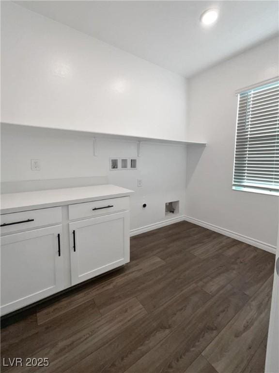 laundry room featuring washer hookup, electric dryer hookup, cabinets, and dark wood-type flooring