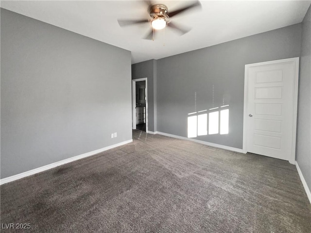 unfurnished room featuring dark colored carpet and ceiling fan