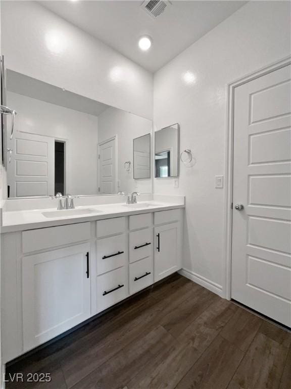 bathroom with vanity and hardwood / wood-style flooring