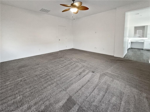 unfurnished room featuring dark carpet and ceiling fan