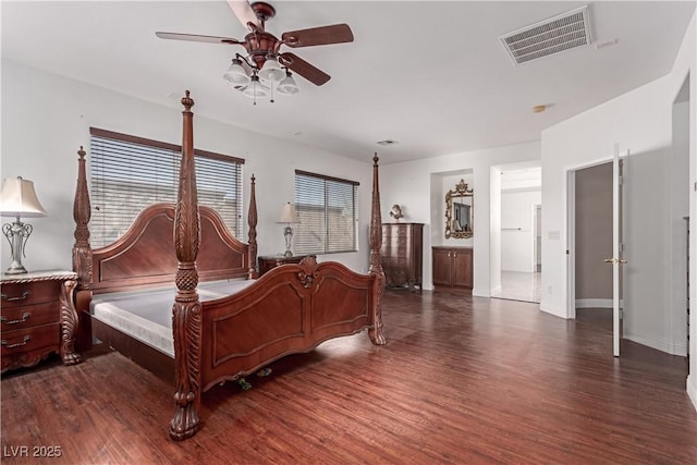 bedroom featuring ceiling fan, connected bathroom, and dark hardwood / wood-style floors