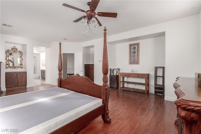 bedroom with dark wood-type flooring, ceiling fan, and ensuite bathroom