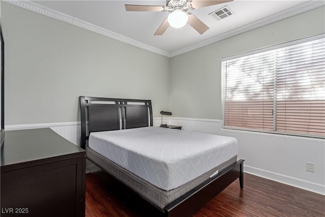 bedroom featuring ceiling fan, dark hardwood / wood-style floors, and crown molding