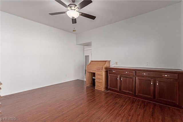 unfurnished living room featuring dark wood-type flooring and ceiling fan