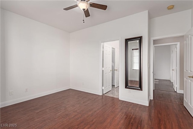 interior space featuring dark wood-type flooring and ceiling fan