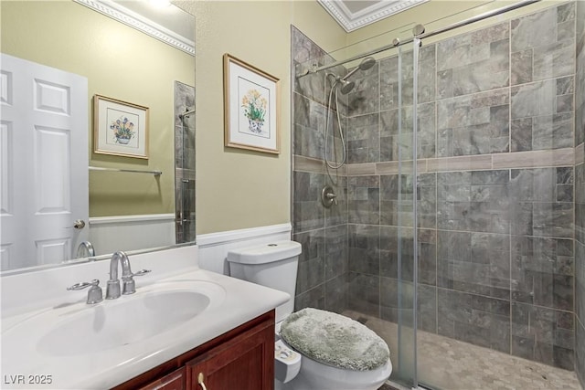 bathroom featuring toilet, ornamental molding, an enclosed shower, and vanity