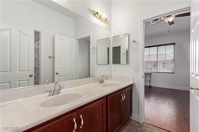 bathroom with ceiling fan and vanity