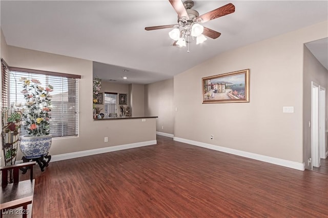 living room with ceiling fan and dark hardwood / wood-style flooring