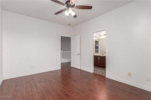 unfurnished bedroom with ceiling fan, sink, dark hardwood / wood-style flooring, and ensuite bath