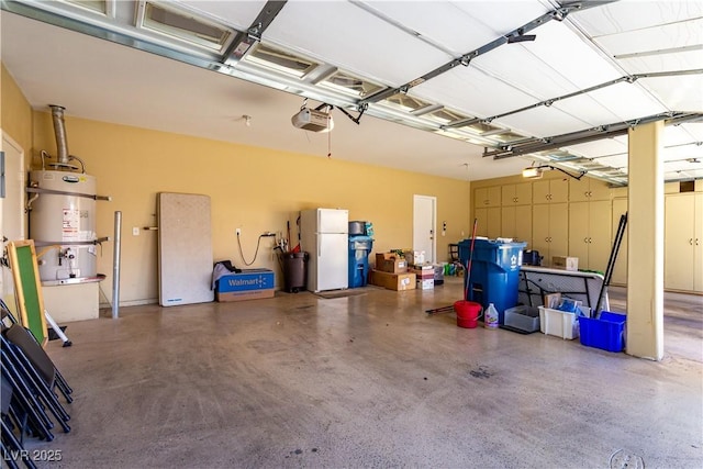 garage with a garage door opener, white refrigerator, and strapped water heater