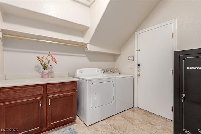 washroom with cabinets and washing machine and dryer