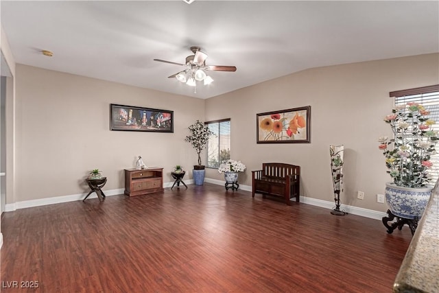 sitting room with ceiling fan, dark wood-type flooring, and lofted ceiling