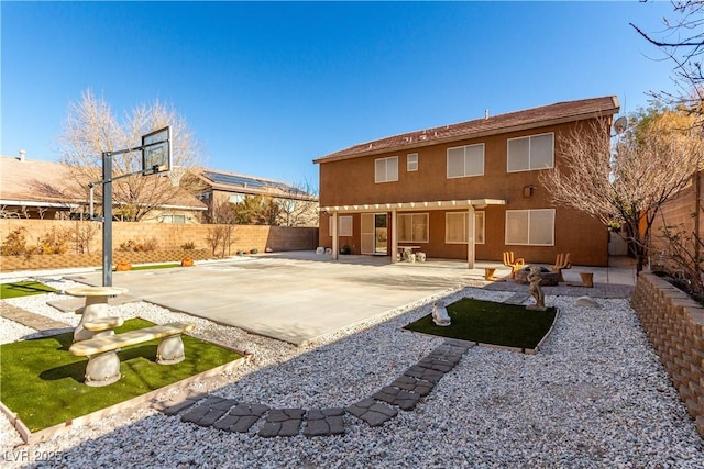 rear view of house with a patio area and an outdoor fire pit