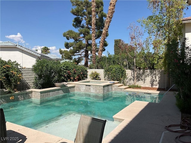 view of swimming pool with an in ground hot tub