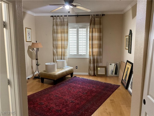 sitting room with ceiling fan, light hardwood / wood-style flooring, and ornamental molding