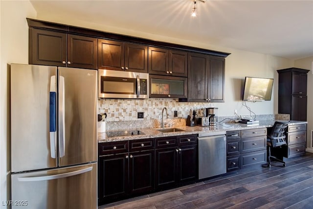 kitchen featuring light stone counters, sink, dark brown cabinetry, and stainless steel appliances