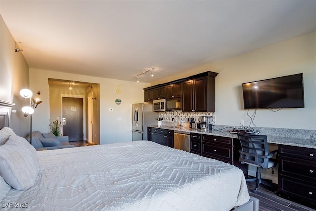 bedroom featuring stainless steel refrigerator