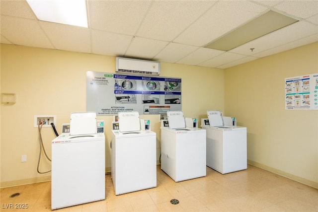 laundry area featuring a wall mounted AC and washer and clothes dryer