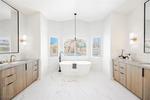 bathroom with vanity and a bath