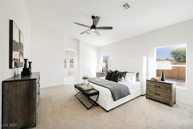 carpeted bedroom featuring ensuite bath and ceiling fan