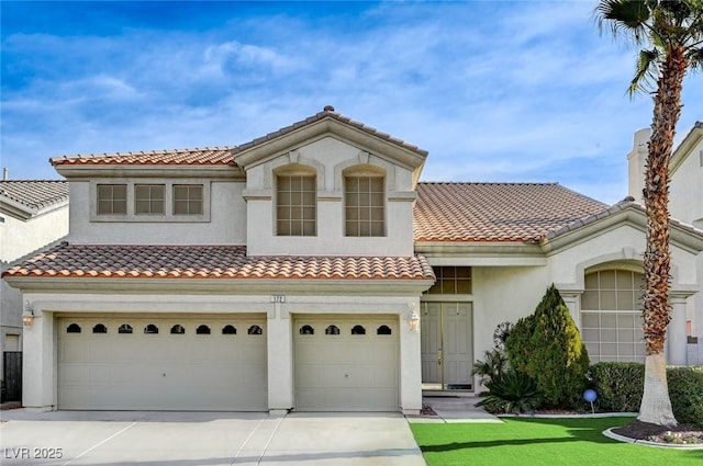 mediterranean / spanish home featuring a garage